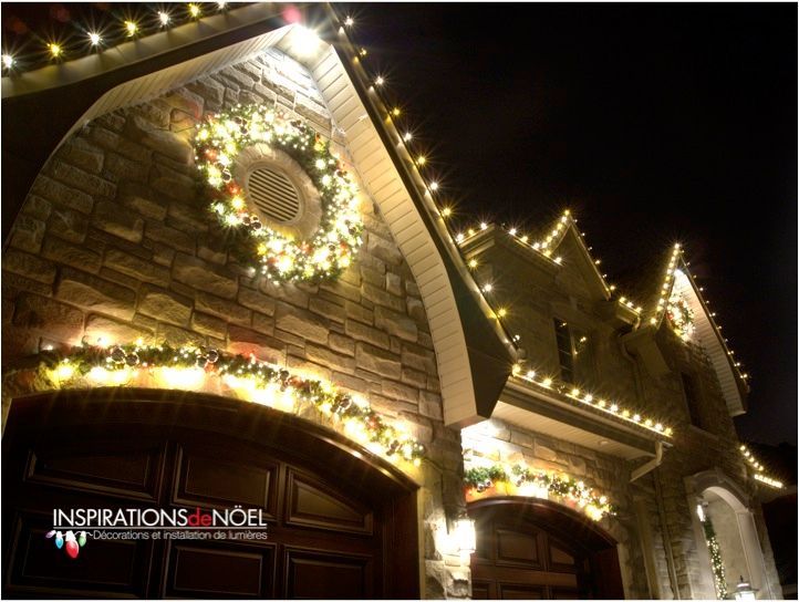 A house is decorated with christmas lights and a wreath.