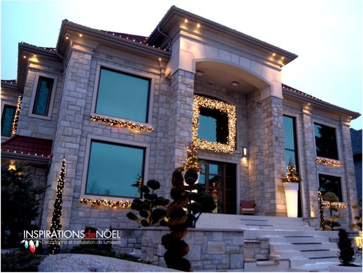 A large house with a christmas tree in front of it