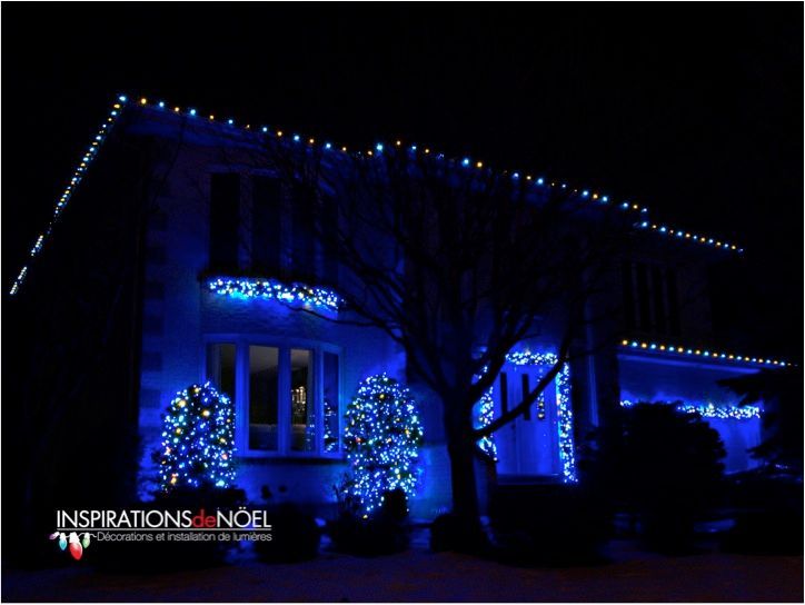 A house decorated with blue lights and the words inspirations noel on the bottom
