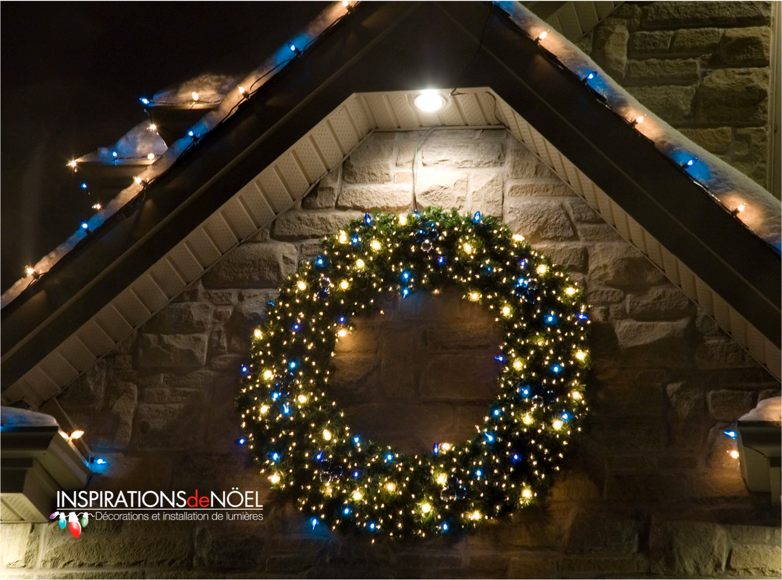 A christmas wreath is hanging on a stone wall