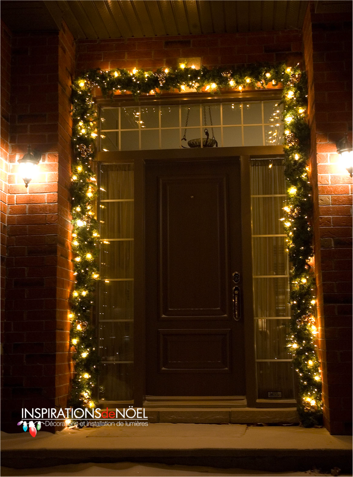 The front door of a house is decorated with christmas lights