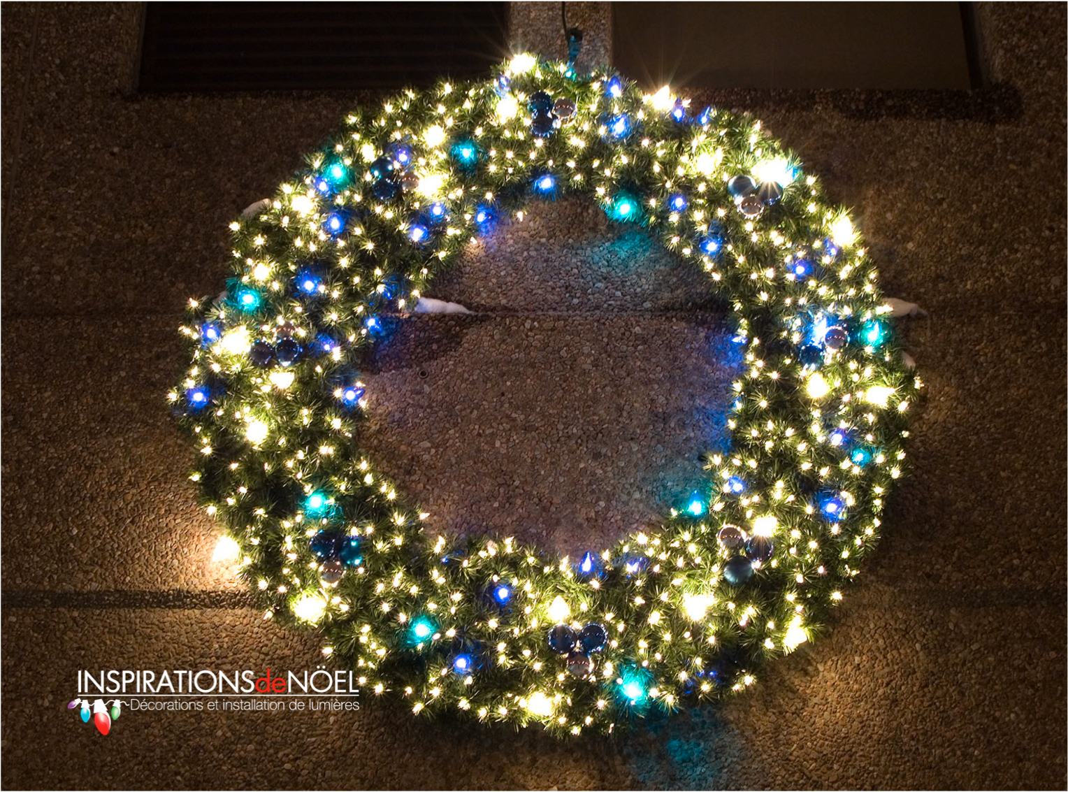 A christmas wreath with blue and gold lights and decorations
