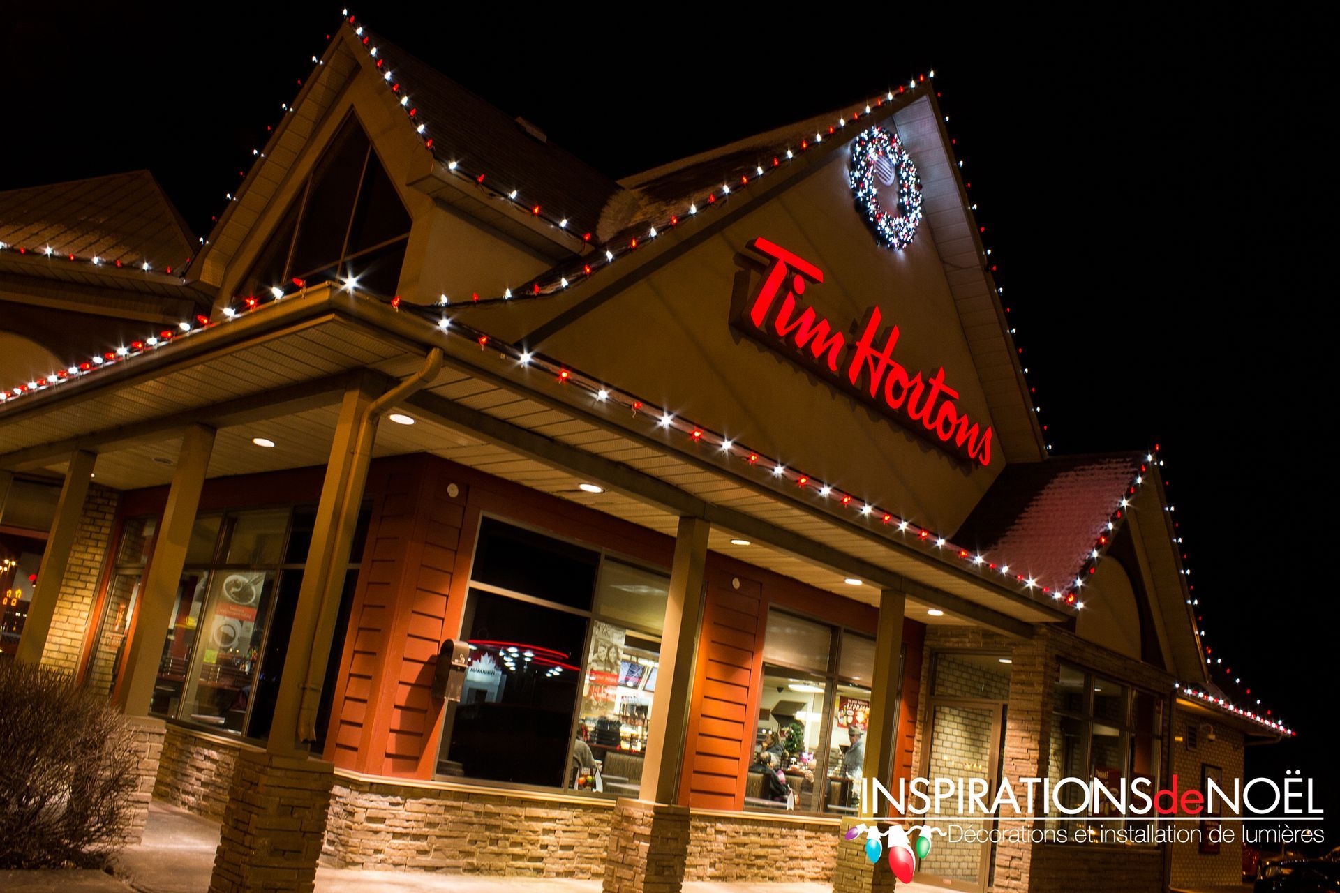 A tim hortons restaurant is decorated with christmas lights