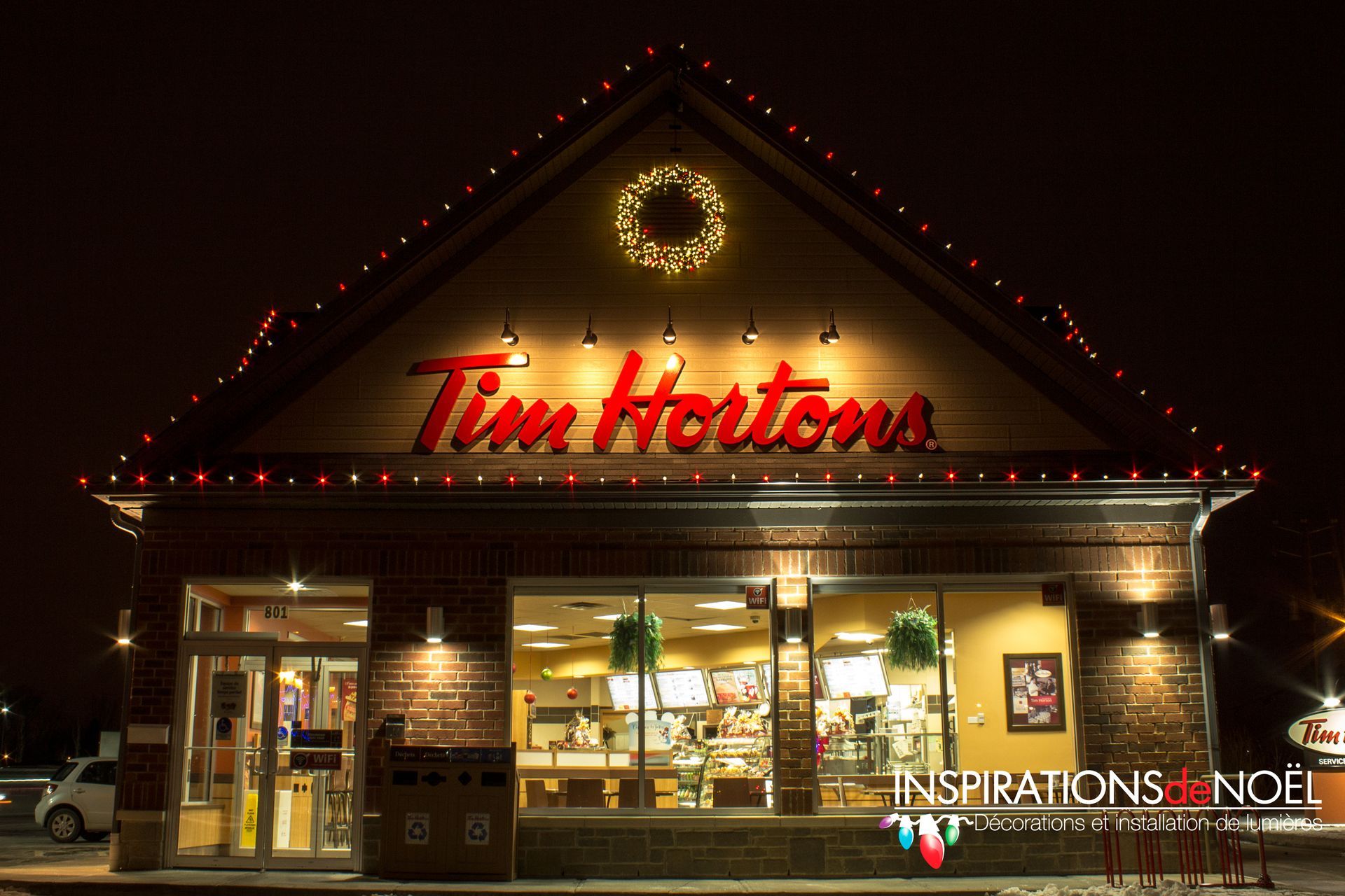 A tim hortons restaurant is lit up at night