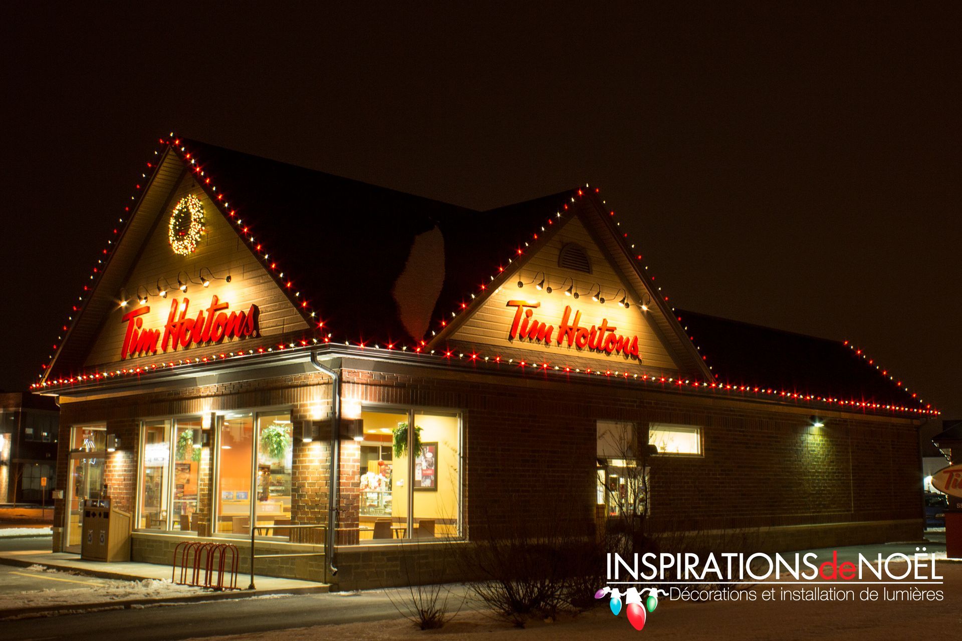 A tim hortons restaurant is lit up with christmas lights