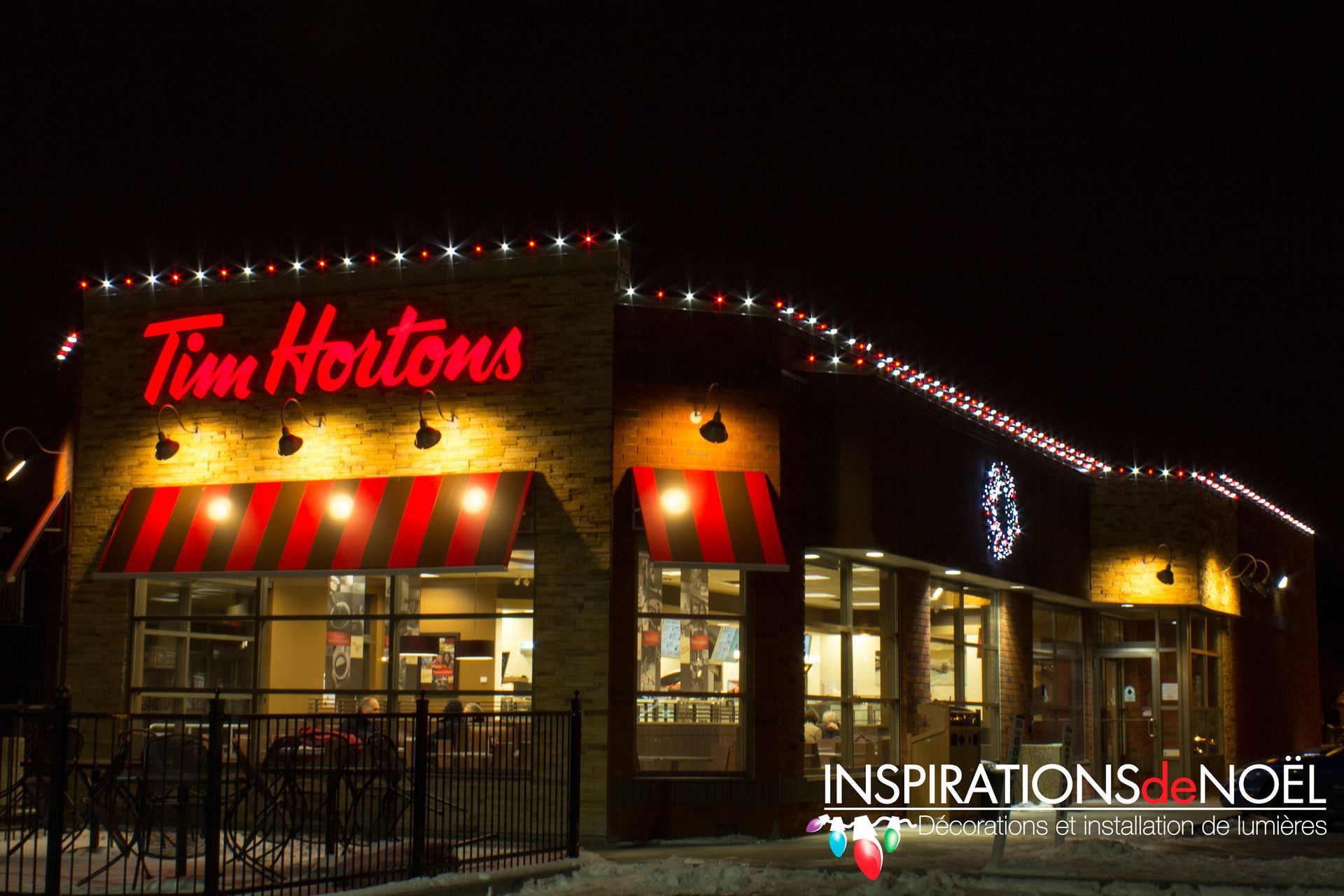 A tim hortons restaurant is lit up at night