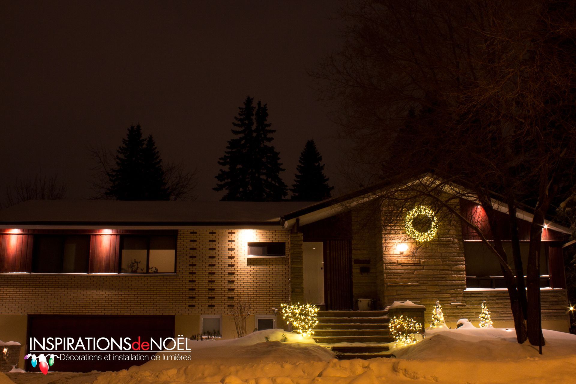 A house is decorated with christmas lights and a wreath