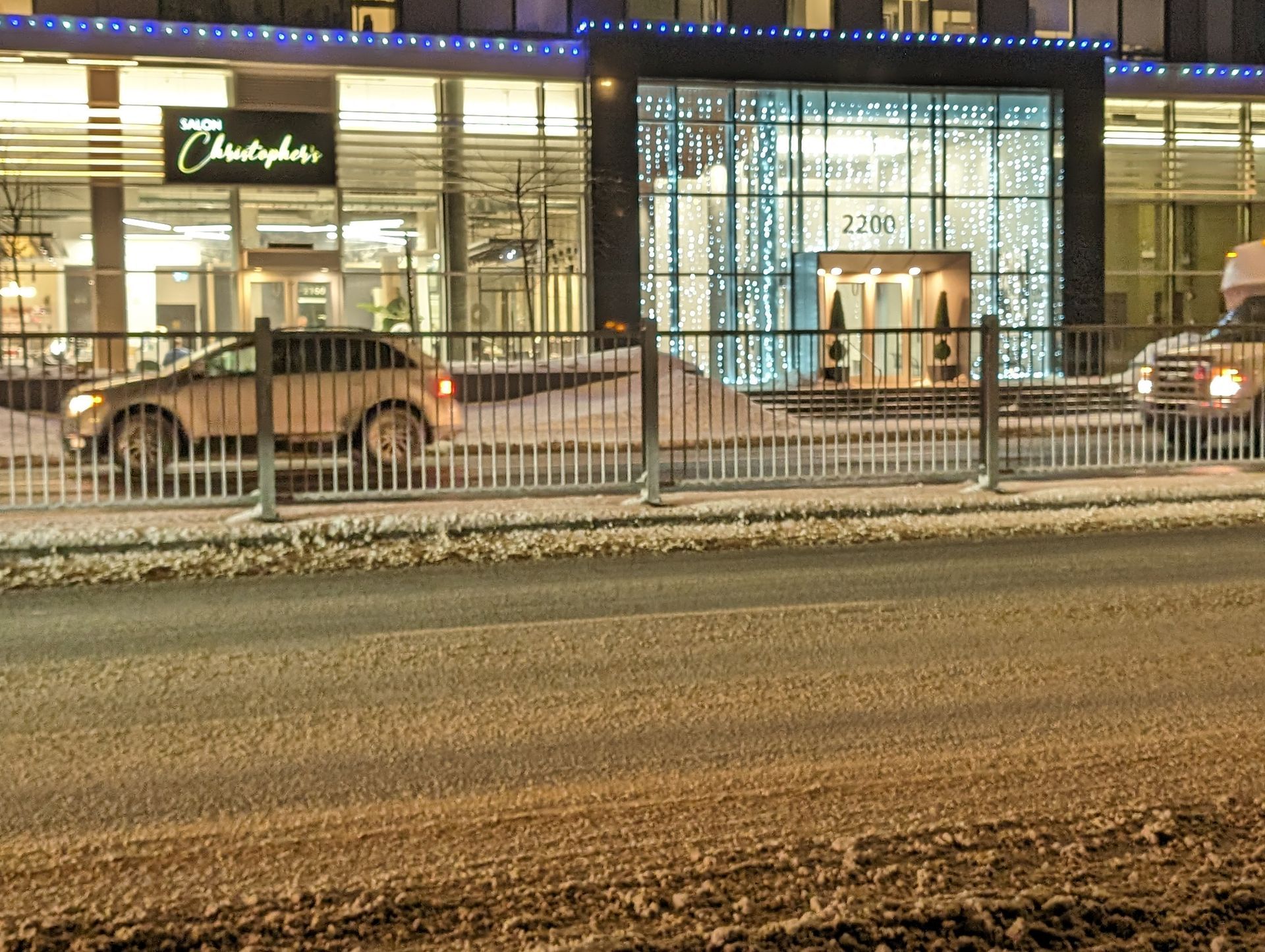 A car is parked in front of a building that says christopher