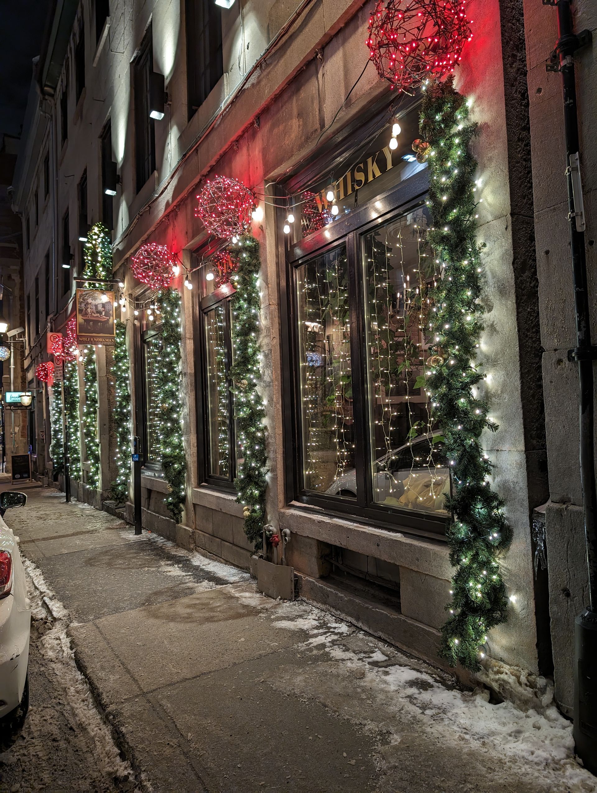 A building is decorated with christmas lights and wreaths.