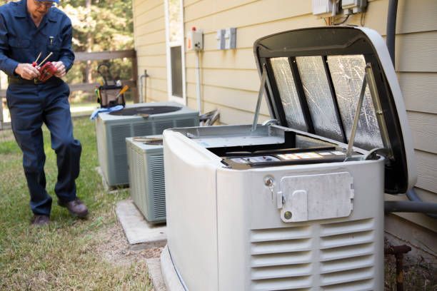 Technician working on a generator outside a house with air conditioning units.