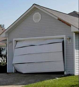 Person lifting the garage gates to open them.