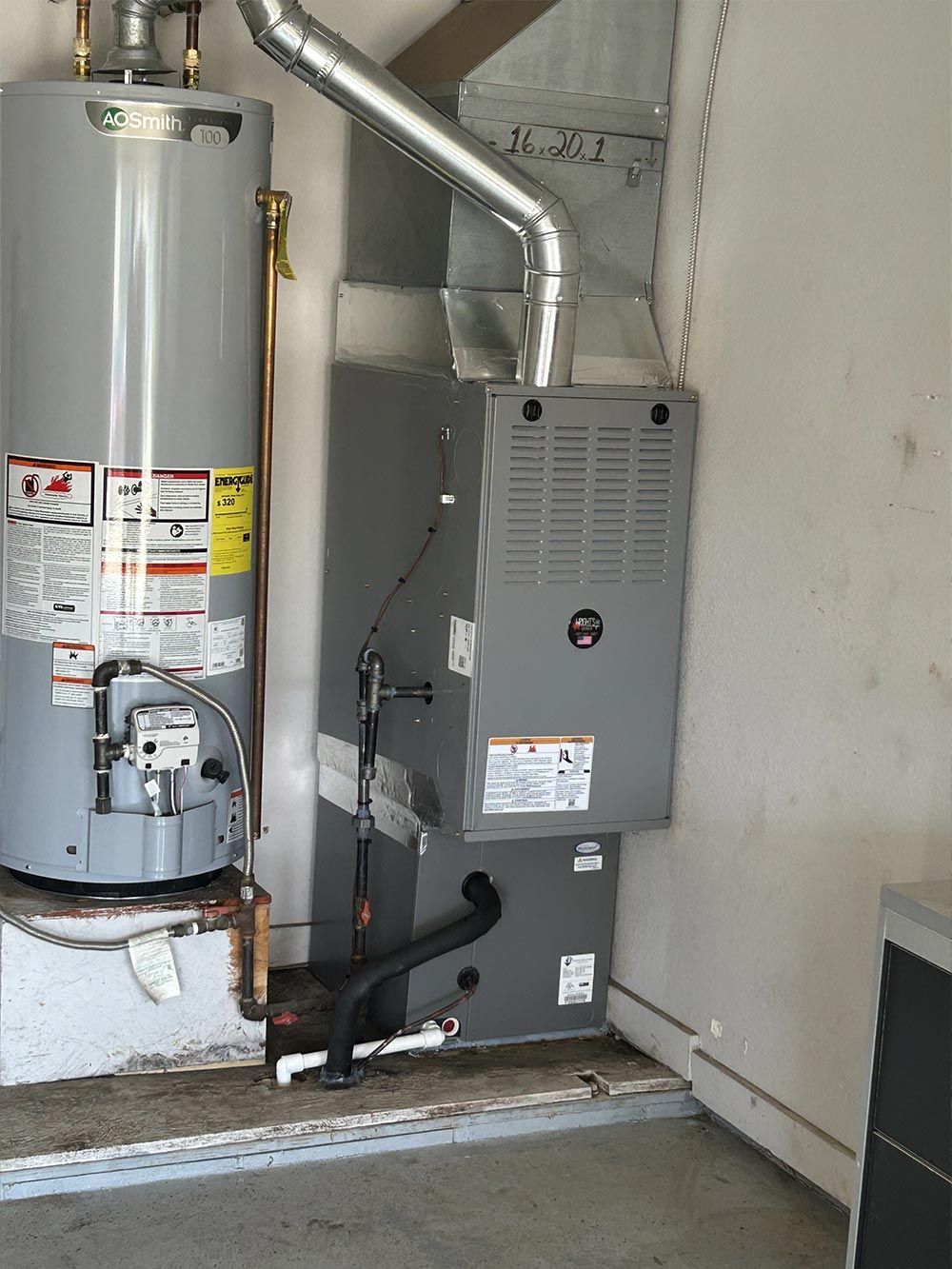 A water heater and a furnace in a garage