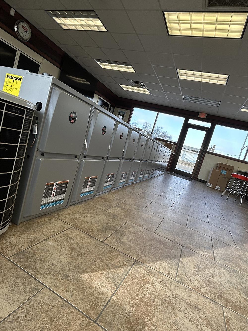 A laundromat with a lot of lockers and a clock on the wall.