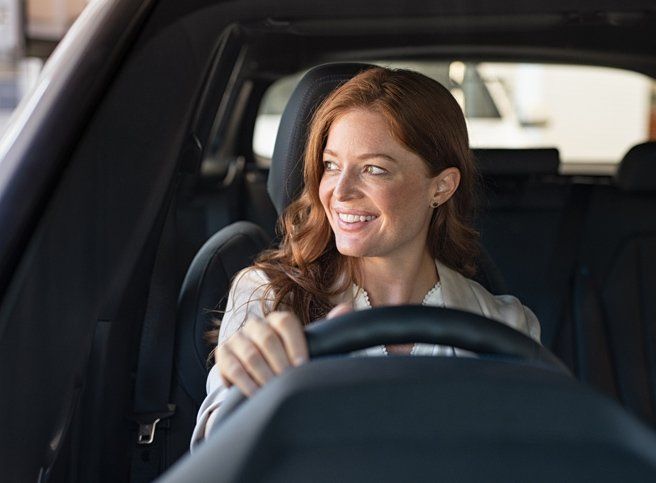 Woman Smiling While Driving Car — Hornsby, NSW — Drive EZY