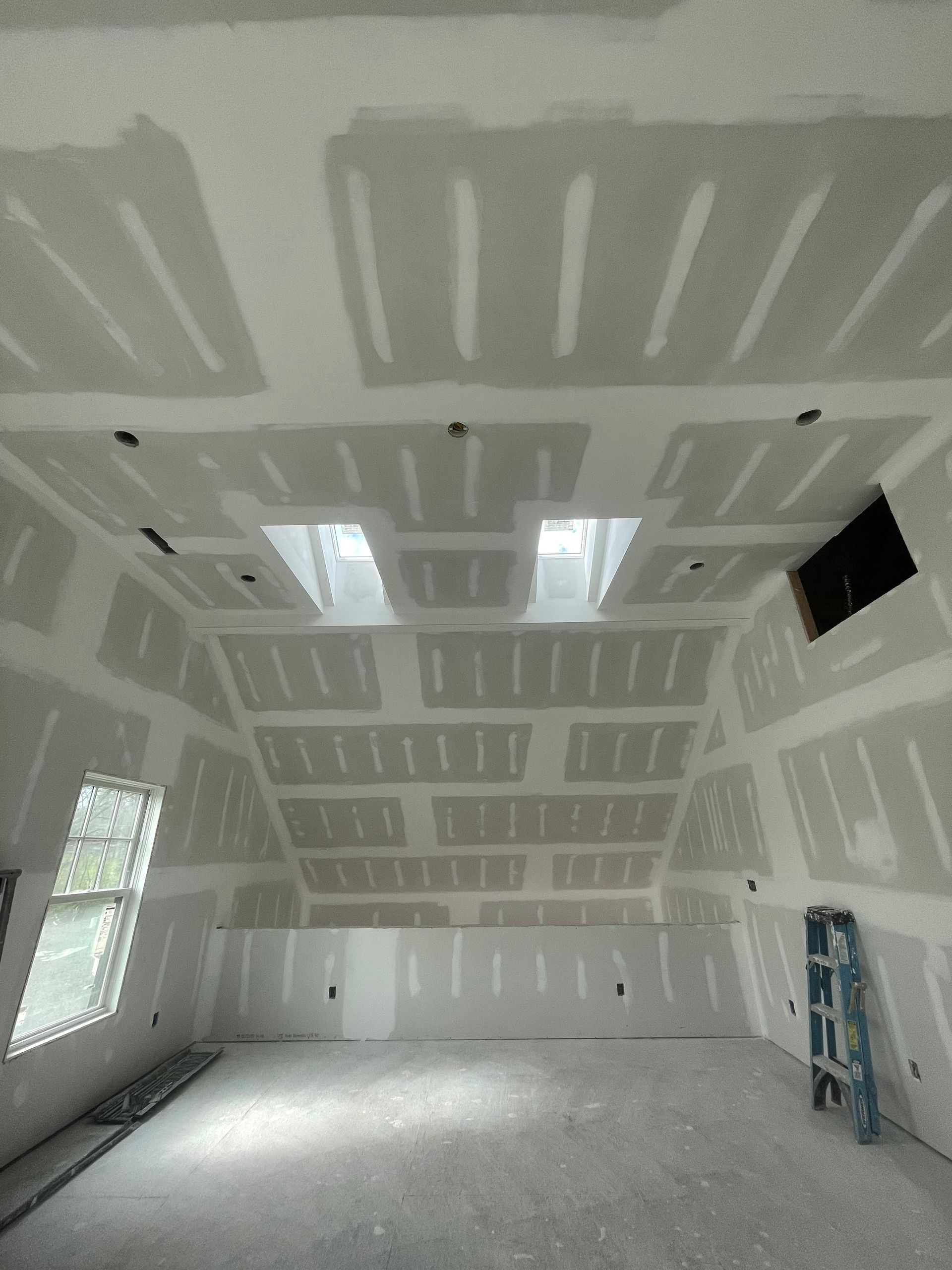 a living room with a couch , chairs , coffee table and ceiling fan .