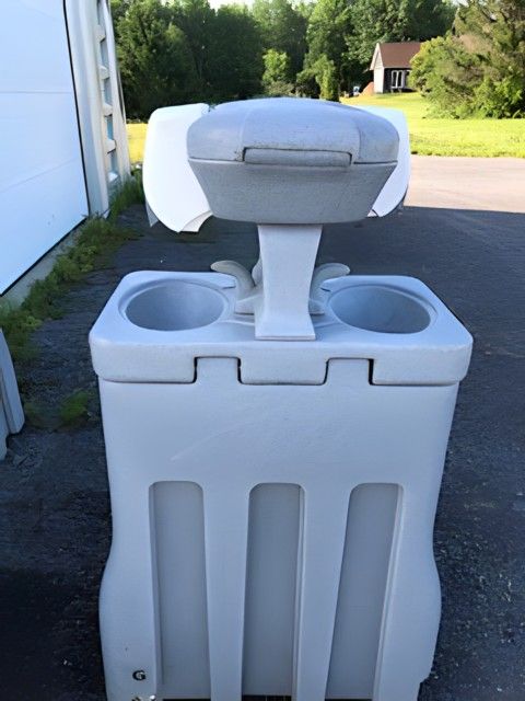 A white portable sink with two cup holders. Brazeau Sanitation