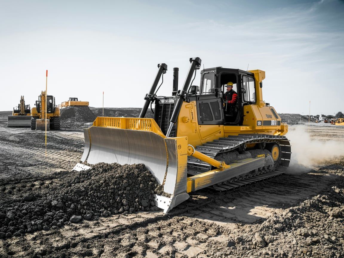 Yellow bulldozer pushing dirt on a construction site.