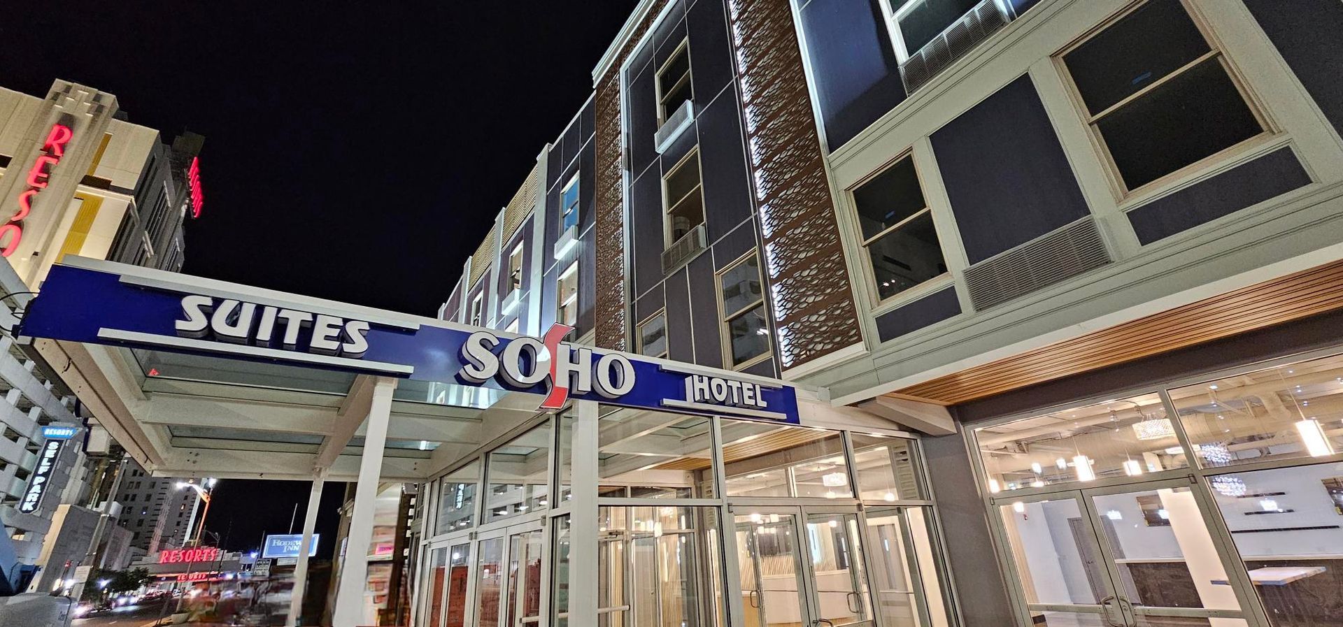 A large building with a sign that says suites soho on it.