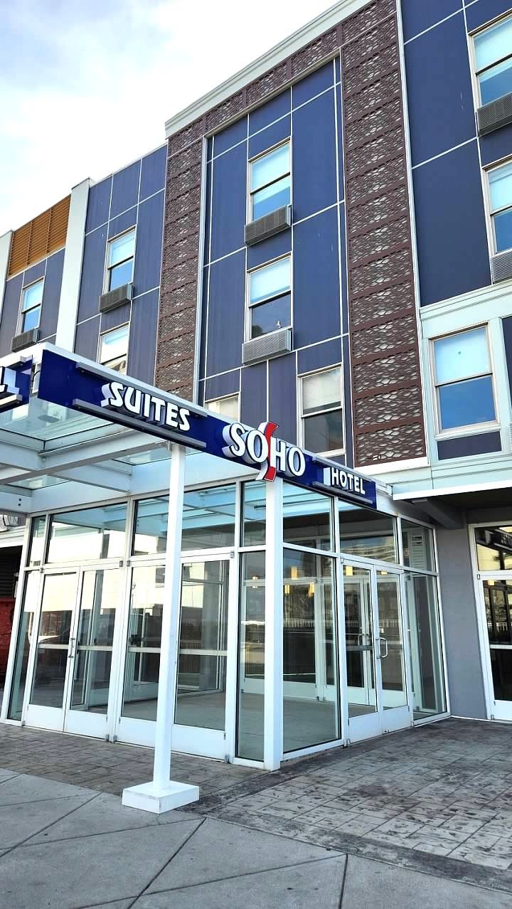 A large building with a sign that says suites on it