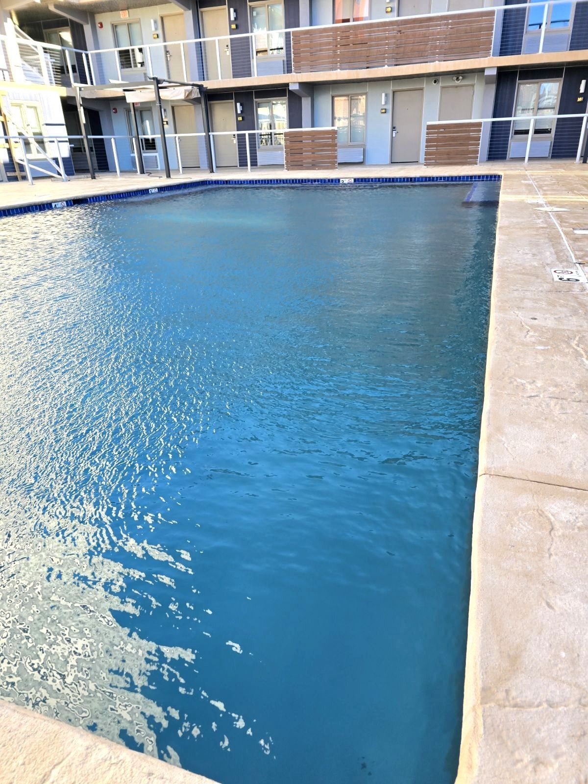 A large swimming pool in front of a building