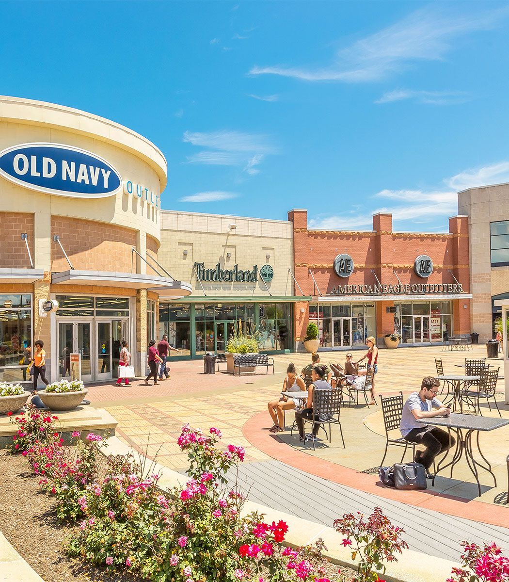 A photo of name brand stores in an exterior setting