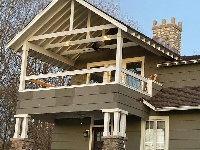 A house with a balcony and a chimney on the roof