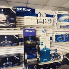 A store filled with lots of pool supplies including a polaris vacuum cleaner.