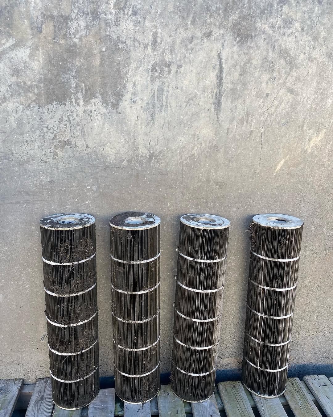A row of wooden poles sitting next to each other on a wooden floor.
