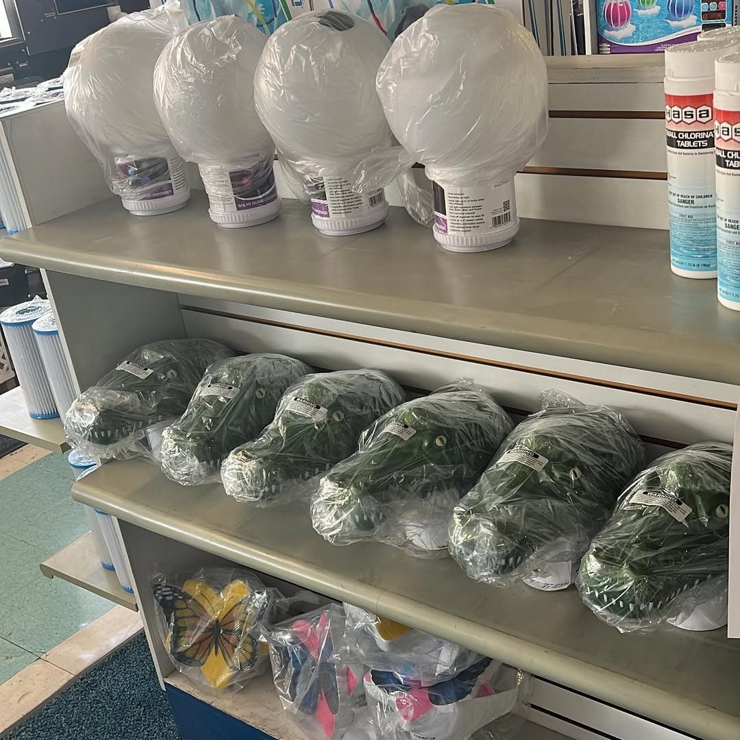 A shelf filled with lots of plastic balls and plants.