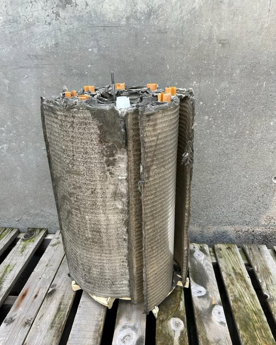 A large piece of concrete is sitting on top of a wooden pallet.