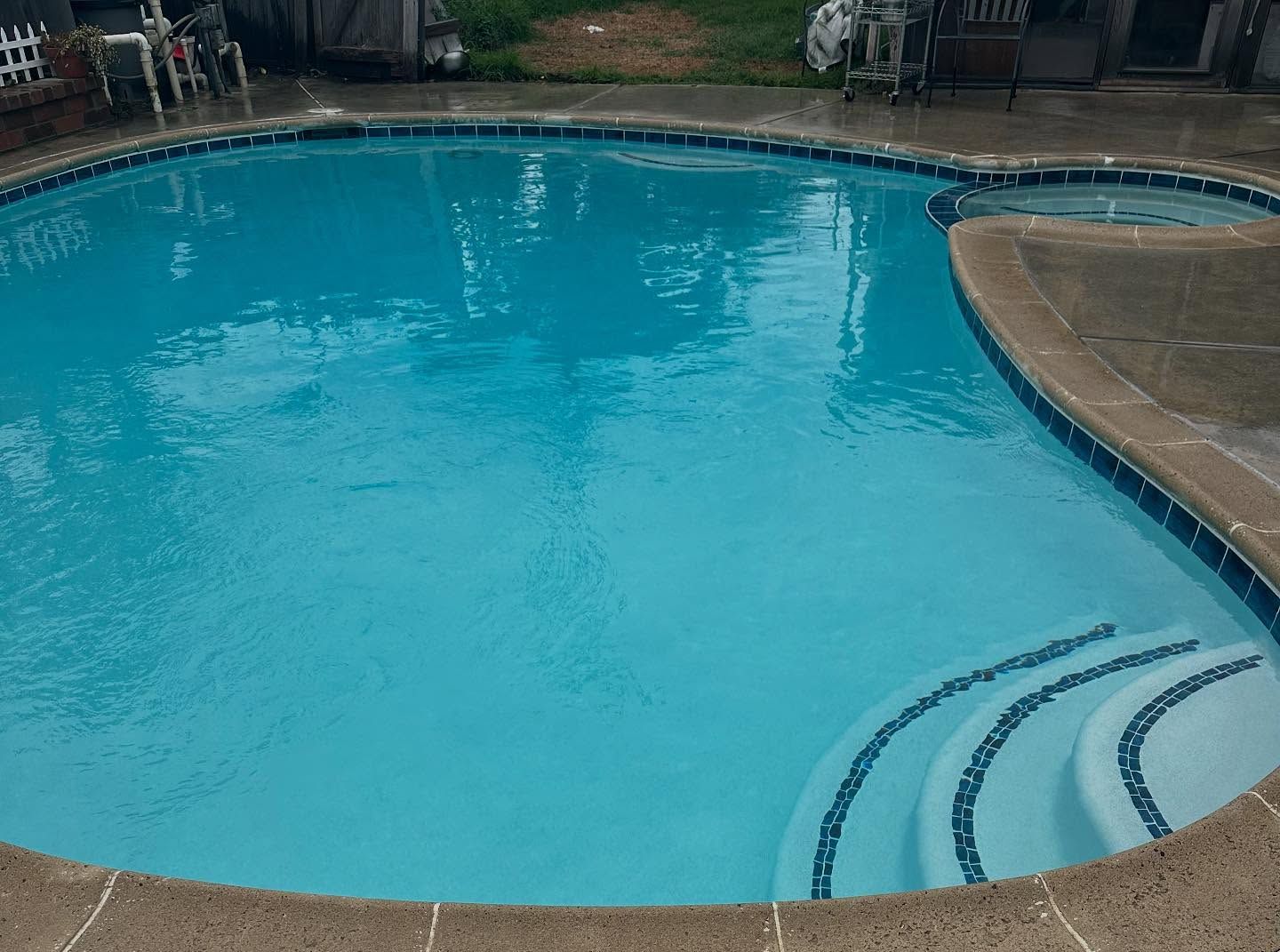 A large swimming pool with stairs leading up to it.