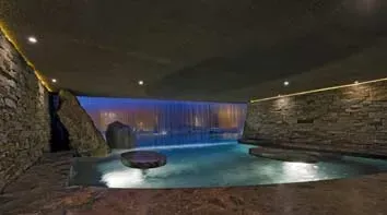 There is a large swimming pool in the middle of the room.