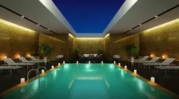 An artist 's impression of a large indoor swimming pool.
