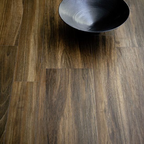 Una ciotola è appoggiata su un pavimento di legno.