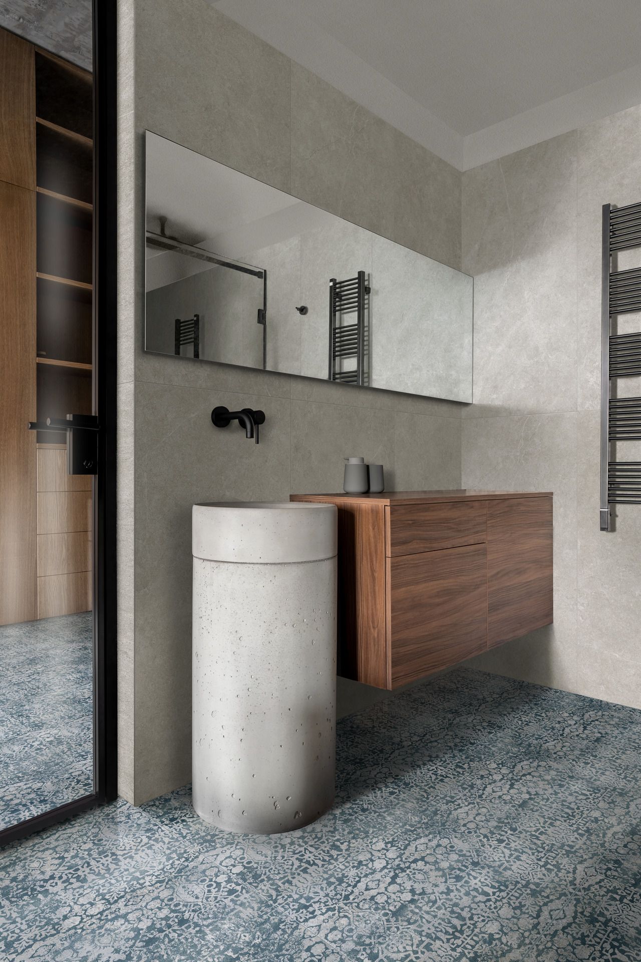 Un bagno con lavandino, specchio e portasciugamani.