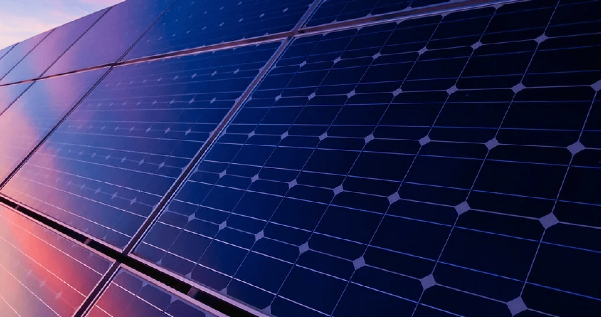 A close up of a row of solar panels against a blue sky.