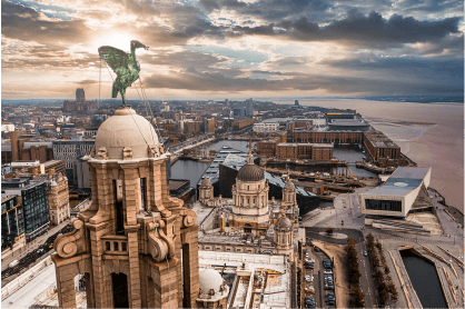 An aerial view of a city with a statue of a horse on top of a building.