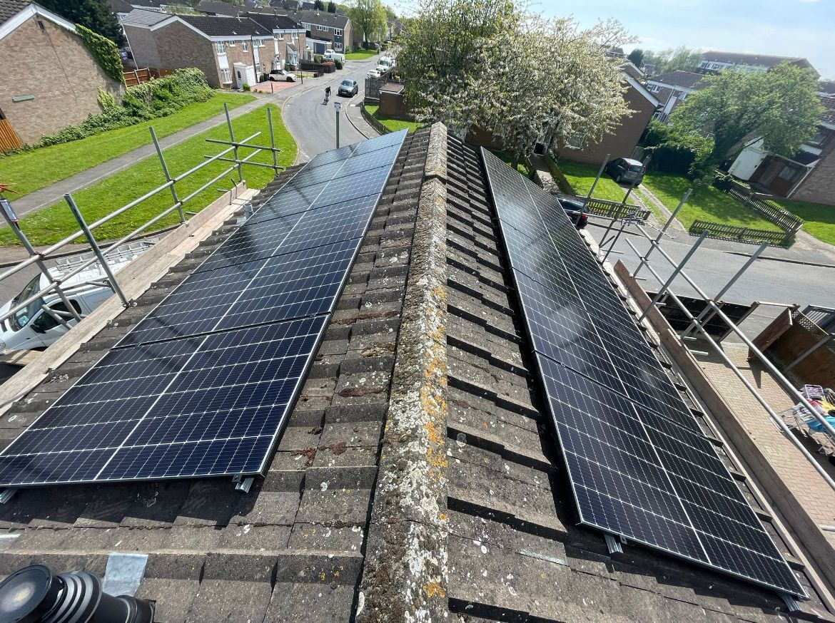 There are two solar panels on the roof of a house.