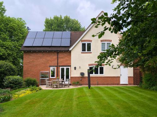 A large house with a lush green lawn in front of it