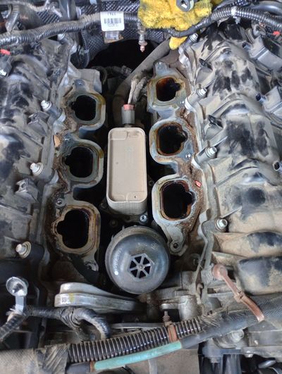 A close up of a car engine with the intake manifold removed.