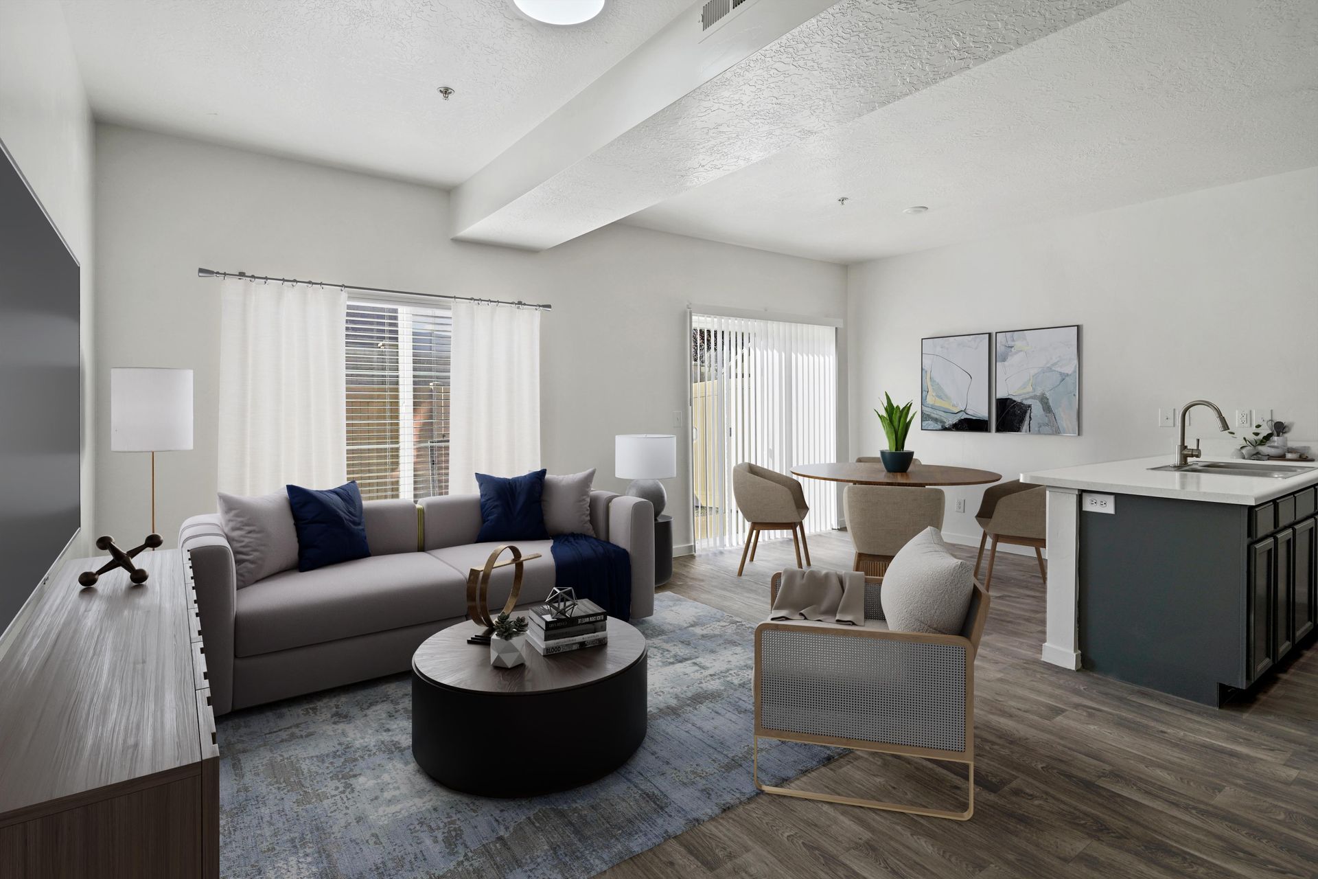 Open-concept living room and dining area with sofa, coffee table, and kitchen island.