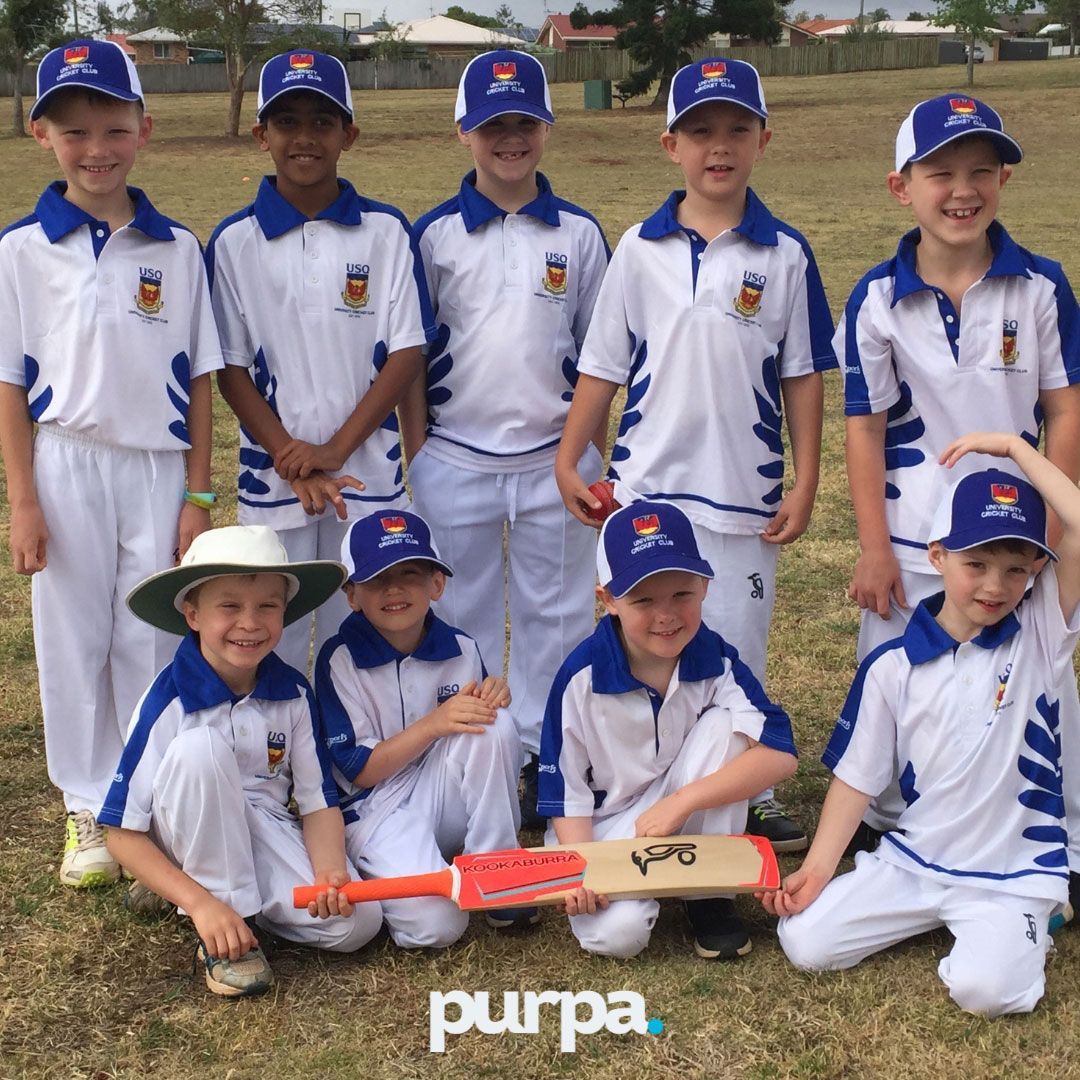 a group of junior cricket players posing for a team photo