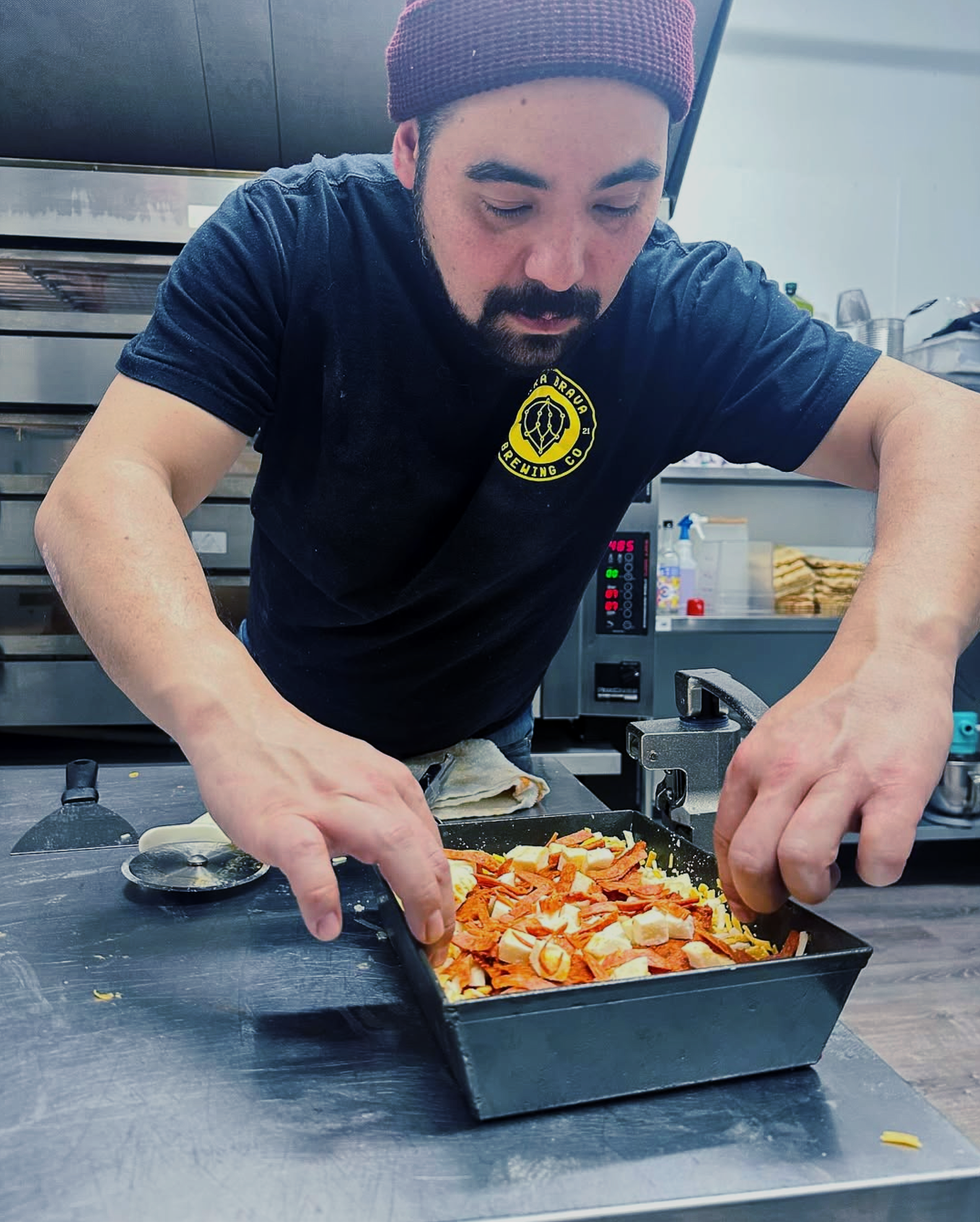 Alejandro Roman of Grumpy Pies Detroit Style Pizza preps a specialty.