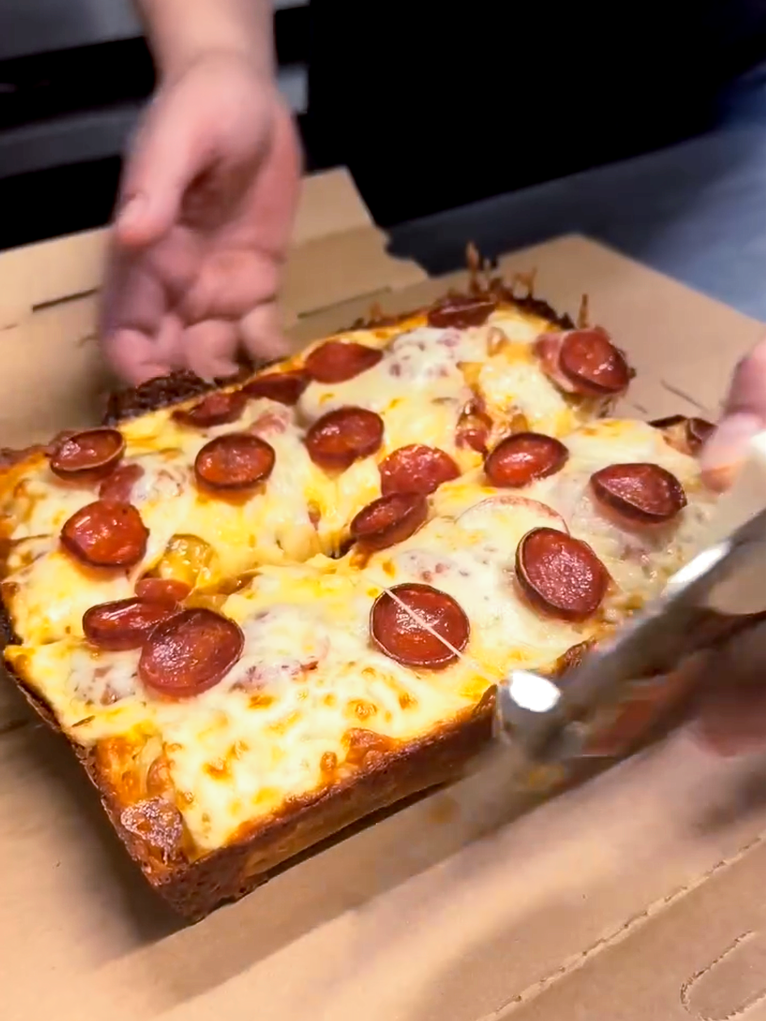 Grumpy Pies Pizza getting sliced and boxed for to-go order