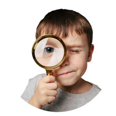 Boy looking through a magnifying glass, squinting at his eye, curious expression.