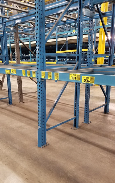 A large room with tables and chairs and a lot of windows.