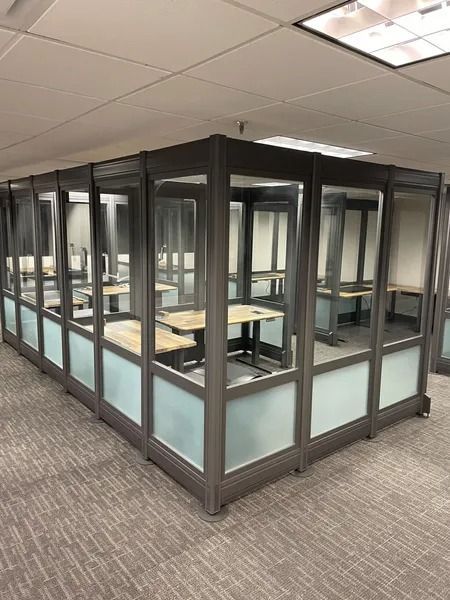 A room with a lot of windows and tables in it.