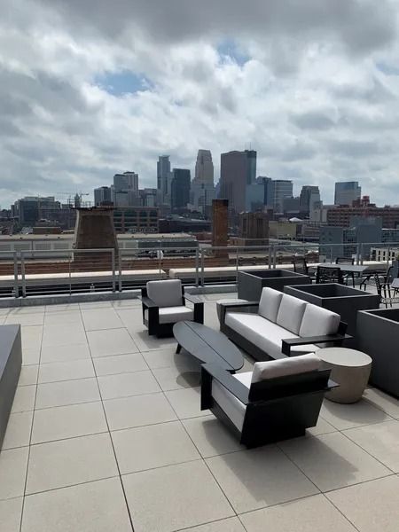 A rooftop patio with a view of the city skyline