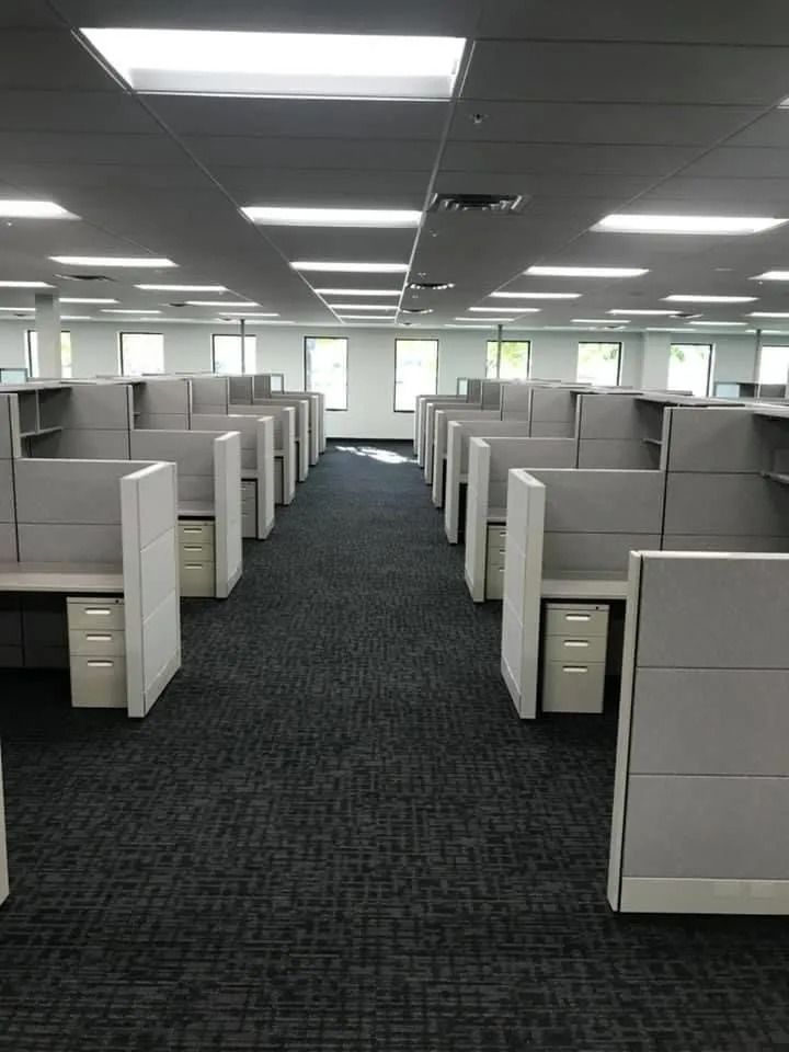 A large office with a lot of cubicles in it