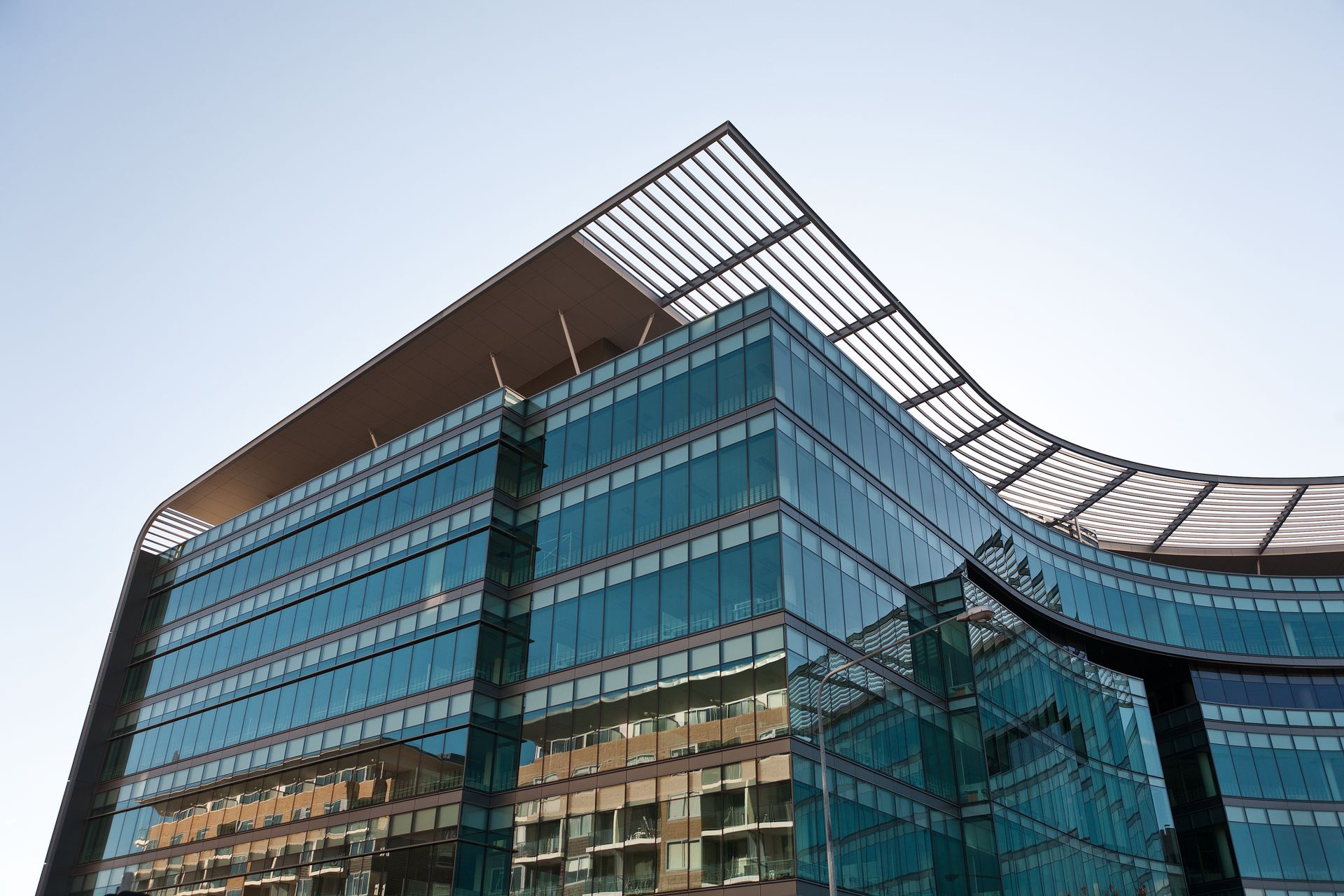 Exterior view of commercial building with windows protected by heat resistant film installation.